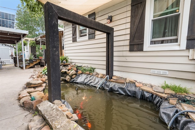 view of property exterior featuring a garden pond