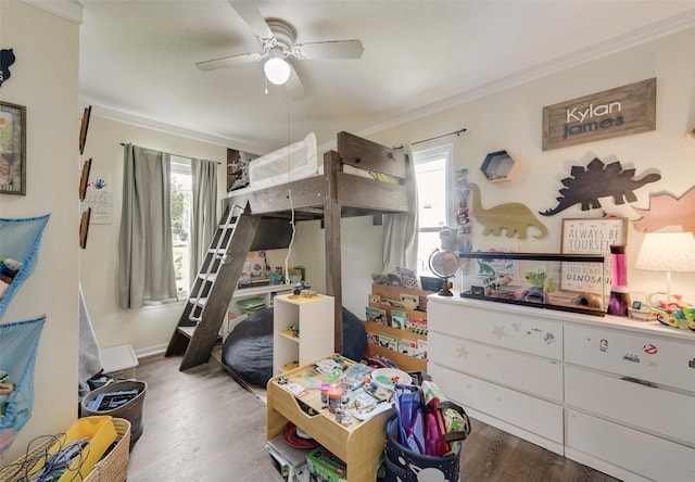 bedroom featuring a ceiling fan, baseboards, ornamental molding, and wood finished floors