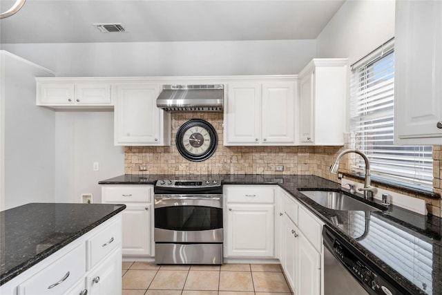 kitchen with visible vents, tasteful backsplash, a sink, ventilation hood, and stainless steel appliances