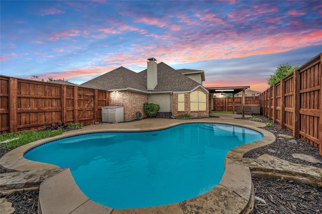10715 Wild Oak Dr, Frisco, TX 75035 - pool at dusk featuring a fenced in pool and a fenced backyard