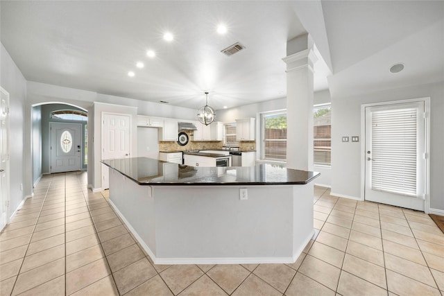 kitchen featuring white cabinets, dark countertops, recessed lighting, tasteful backsplash, and visible vents
