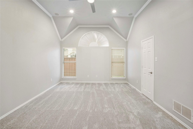 spare room with visible vents, lofted ceiling, baseboards, a ceiling fan, and carpet