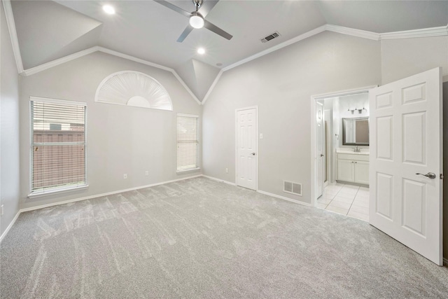 unfurnished bedroom with baseboards, light carpet, lofted ceiling, and visible vents