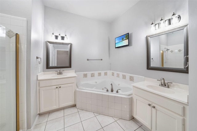 full bath featuring a jetted tub, a sink, tile patterned floors, and a shower stall