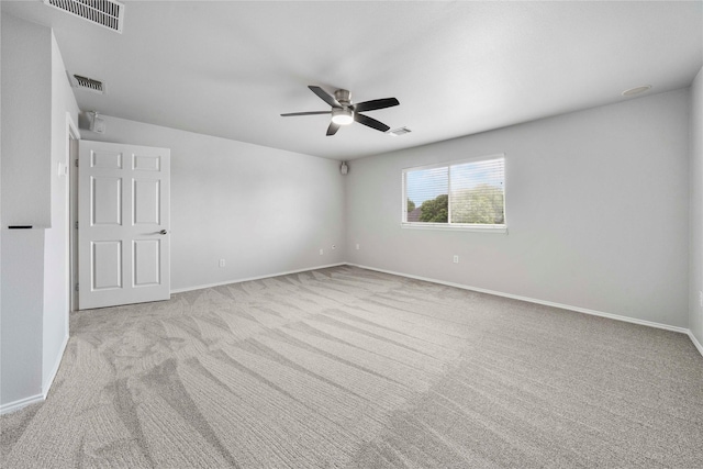 unfurnished room with visible vents, a ceiling fan, and carpet