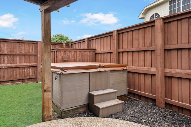 view of yard featuring a hot tub and fence