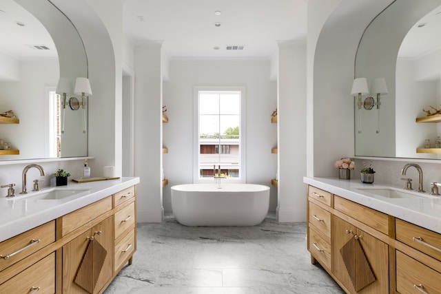 3201 Beverly, Highland Park, TX 75205 - bathroom featuring ornamental molding, two vanities, marble finish floors, a freestanding tub, and backsplash