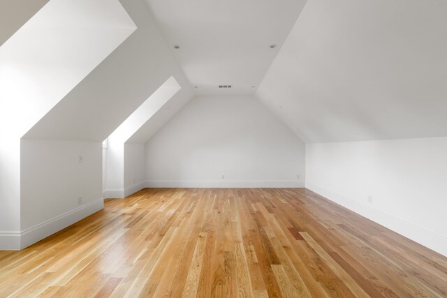 3201 Beverly, Highland Park, TX 75205 - bonus room featuring light wood-style flooring, vaulted ceiling, and baseboards
