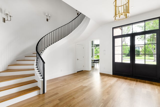 3201 Beverly, Highland Park, TX 75205 - foyer entrance featuring light wood finished floors, baseboards, stairs, and a chandelier