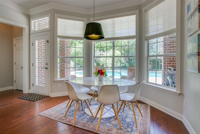 dining space featuring crown molding, baseboards, and dark wood-style flooring