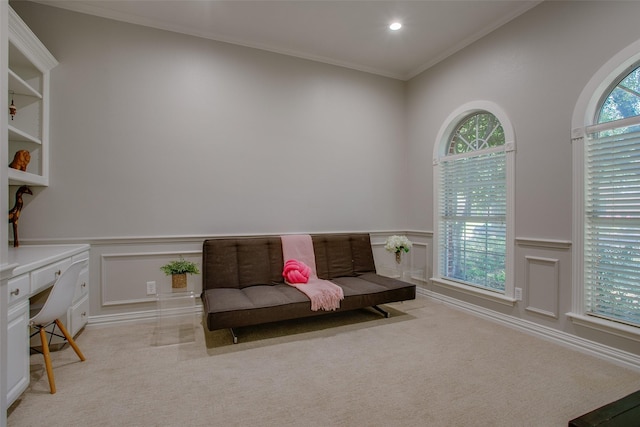 sitting room with wainscoting, a decorative wall, and light carpet