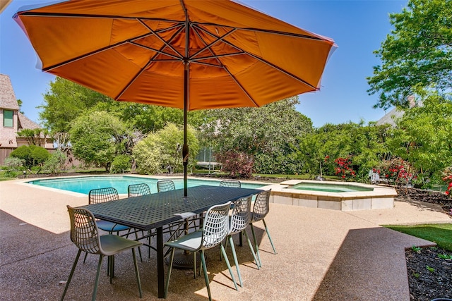pool with outdoor dining area, an in ground hot tub, and a patio area