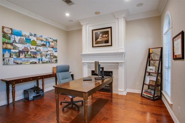 office featuring baseboards, ornamental molding, wood finished floors, and visible vents
