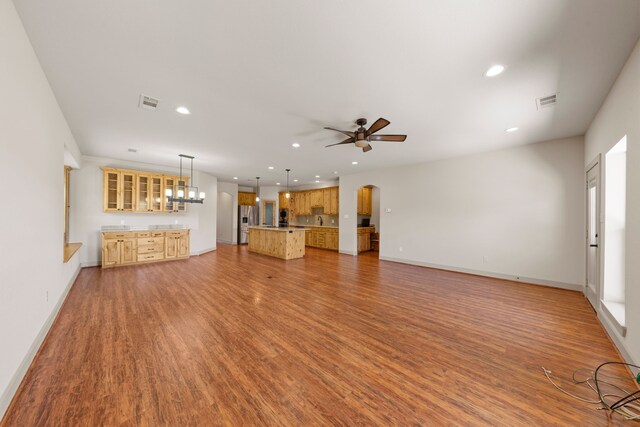 unfurnished living room featuring recessed lighting, ceiling fan, and light wood-style flooring