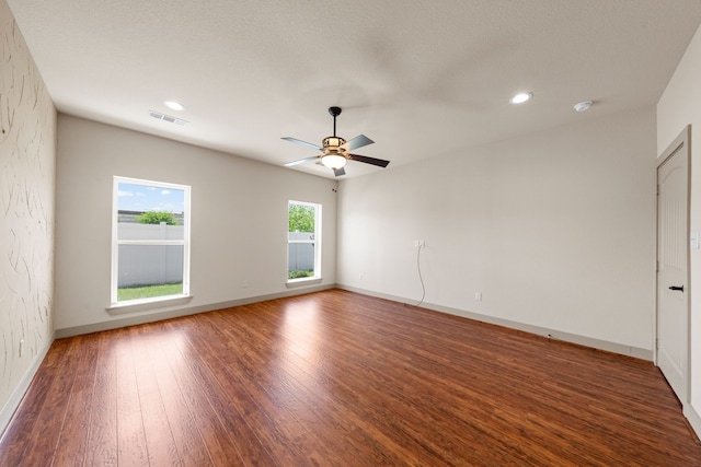 spare room featuring recessed lighting, ceiling fan, visible vents, baseboards, and wood finished floors