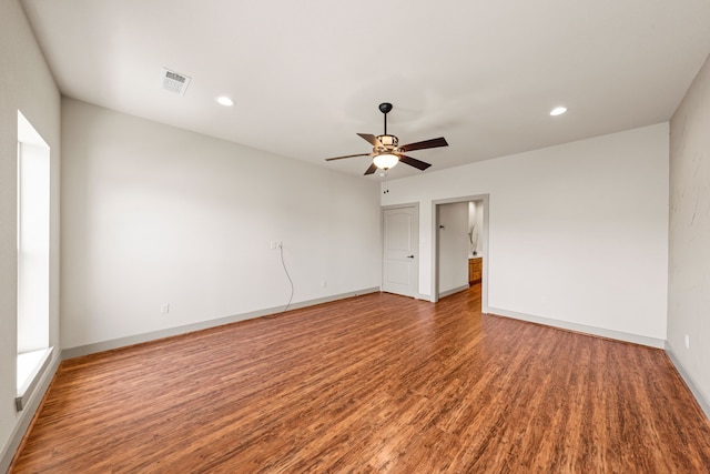 spare room featuring recessed lighting, a ceiling fan, visible vents, baseboards, and wood finished floors