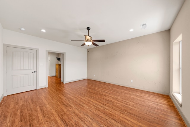 unfurnished room featuring recessed lighting, light wood-style floors, ceiling fan, visible vents, and baseboards