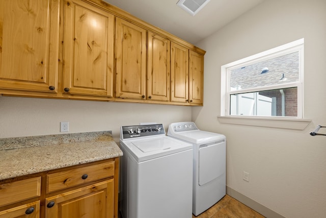 laundry room with cabinet space, baseboards, visible vents, washer and clothes dryer, and light tile patterned flooring