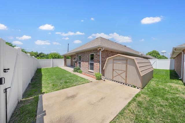 exterior space with a patio, an outbuilding, a storage shed, brick siding, and a fenced backyard
