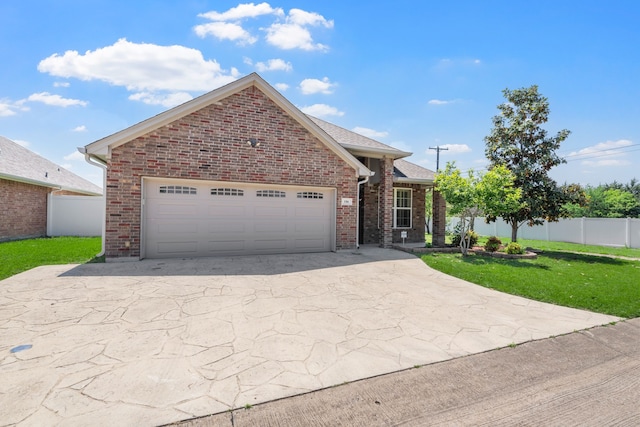 ranch-style house featuring brick siding, fence, a garage, a front lawn, and concrete driveway
