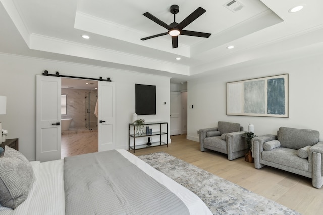 5702 Glen Heather Dr, Dallas, TX 75252 - bedroom featuring a raised ceiling, a barn door, ornamental molding, recessed lighting, and light wood finished floors