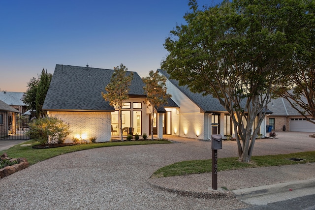 5702 Glen Heather Dr, Dallas, TX 75252 - view of front of property with brick siding, roof with shingles, and curved driveway