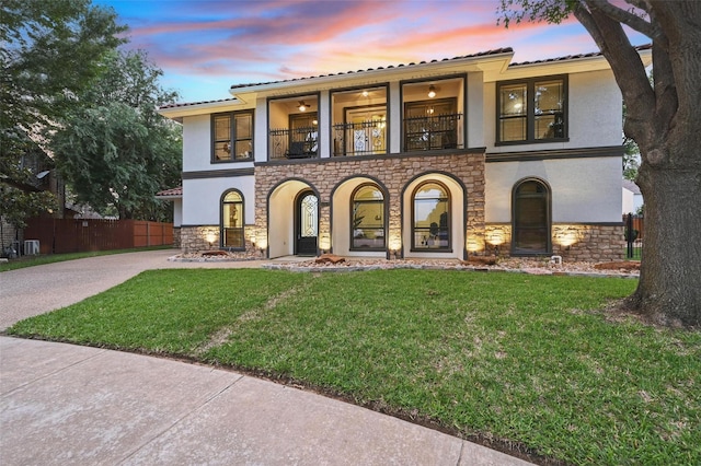 5314 Meritage Ln, Grapevine, TX 76051 - view of front of house featuring a balcony, stone siding, stucco siding, a tile roof, and concrete driveway