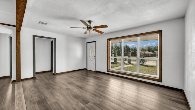 760 College Farm, Stephenville, TX 76401 - empty room with wood finished floors, baseboards, visible vents, a ceiling fan, and a textured ceiling