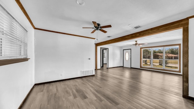 760 College Farm, Stephenville, TX 76401 - unfurnished living room featuring wood finished floors, visible vents, ceiling fan, and baseboards