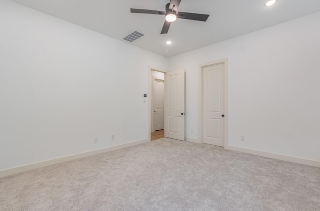 unfurnished bedroom with light colored carpet, baseboards, visible vents, and recessed lighting