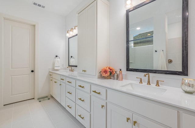 full bathroom with a sink, tile patterned floors, double vanity, and visible vents