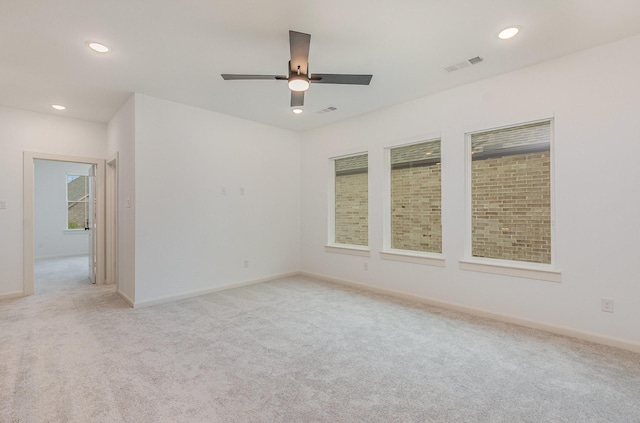 empty room with visible vents, recessed lighting, ceiling fan, and light colored carpet