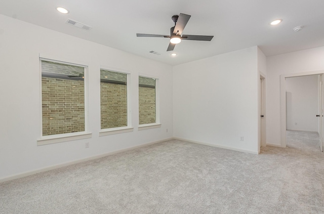 spare room featuring carpet flooring, recessed lighting, and visible vents