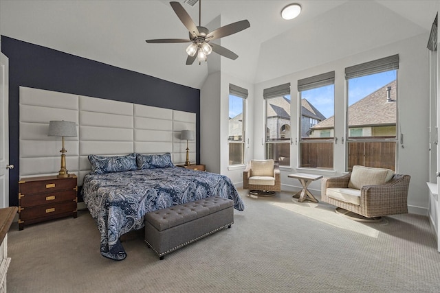 carpeted bedroom with a ceiling fan and vaulted ceiling