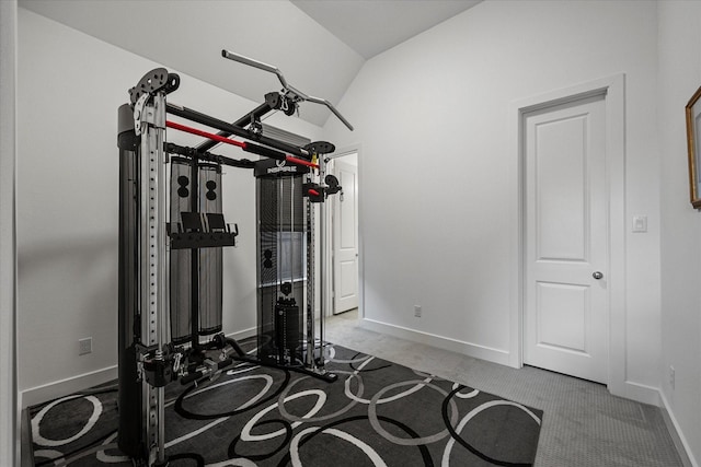 workout room with baseboards, carpet, and vaulted ceiling