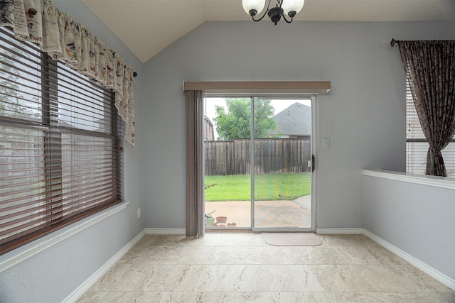 unfurnished dining area featuring baseboards, a notable chandelier, and vaulted ceiling