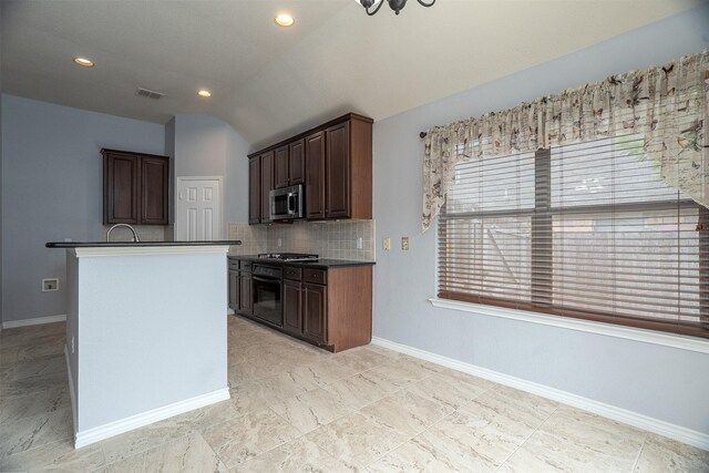 kitchen with stainless steel microwave, black oven, gas stovetop, vaulted ceiling, and backsplash