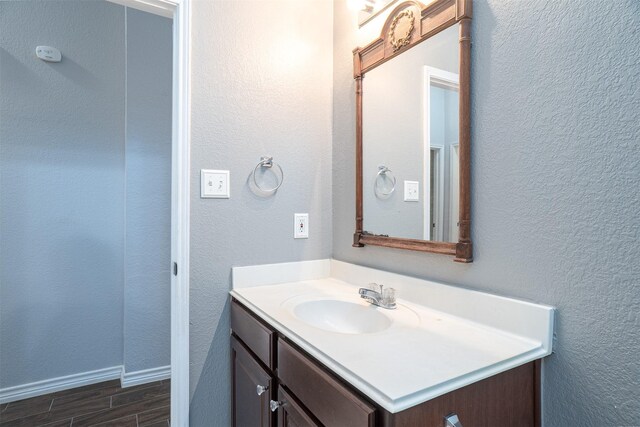bathroom featuring wood finished floors and vanity