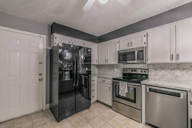 kitchen with a textured ceiling, white cabinetry, stainless steel appliances, and tasteful backsplash