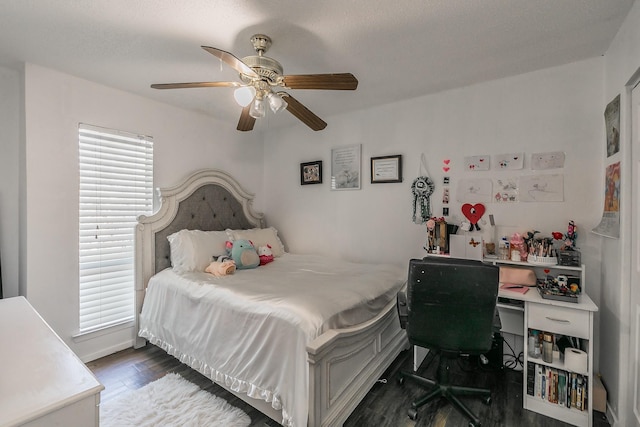 bedroom with a ceiling fan and dark wood finished floors