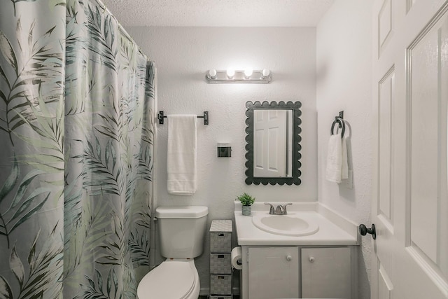 full bath featuring a textured ceiling, vanity, toilet, and curtained shower