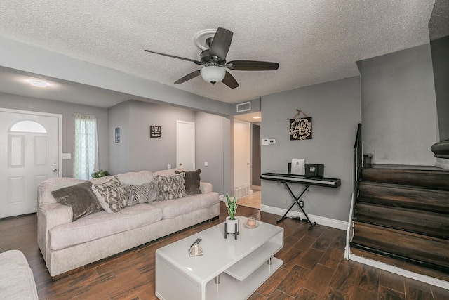 living area with wood finished floors, ceiling fan, baseboards, visible vents, and a textured ceiling