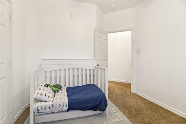 bedroom with baseboards and carpet