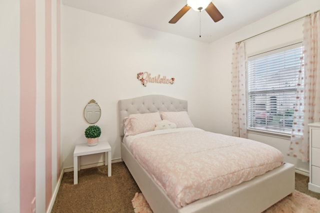 carpeted bedroom featuring baseboards and a ceiling fan