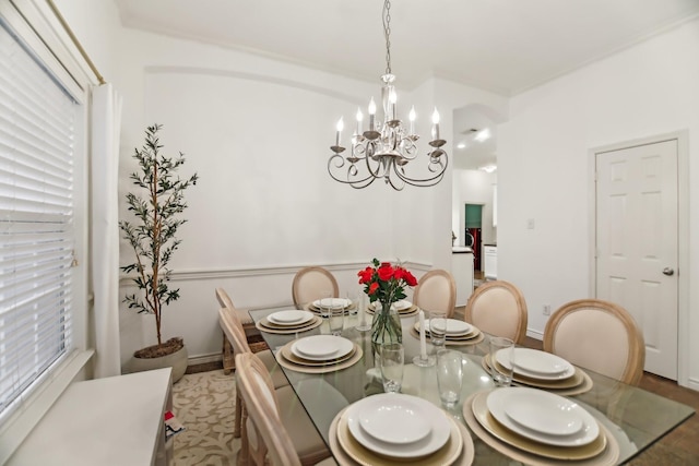 dining room with baseboards and a notable chandelier