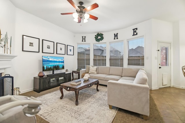 living room with ceiling fan and baseboards