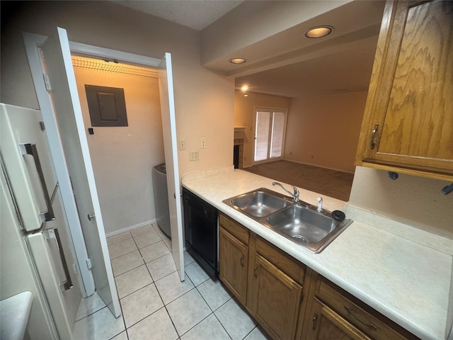 kitchen featuring freestanding refrigerator, light countertops, electric panel, dishwasher, and a sink