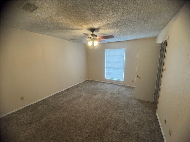 empty room with visible vents, a textured ceiling, ceiling fan, and carpet flooring