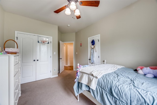 carpeted bedroom featuring a ceiling fan, baseboards, and a closet