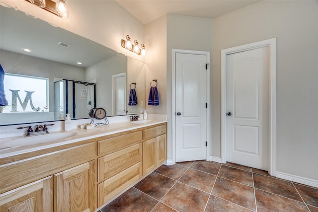 bathroom with visible vents, tile patterned flooring, double vanity, and a sink